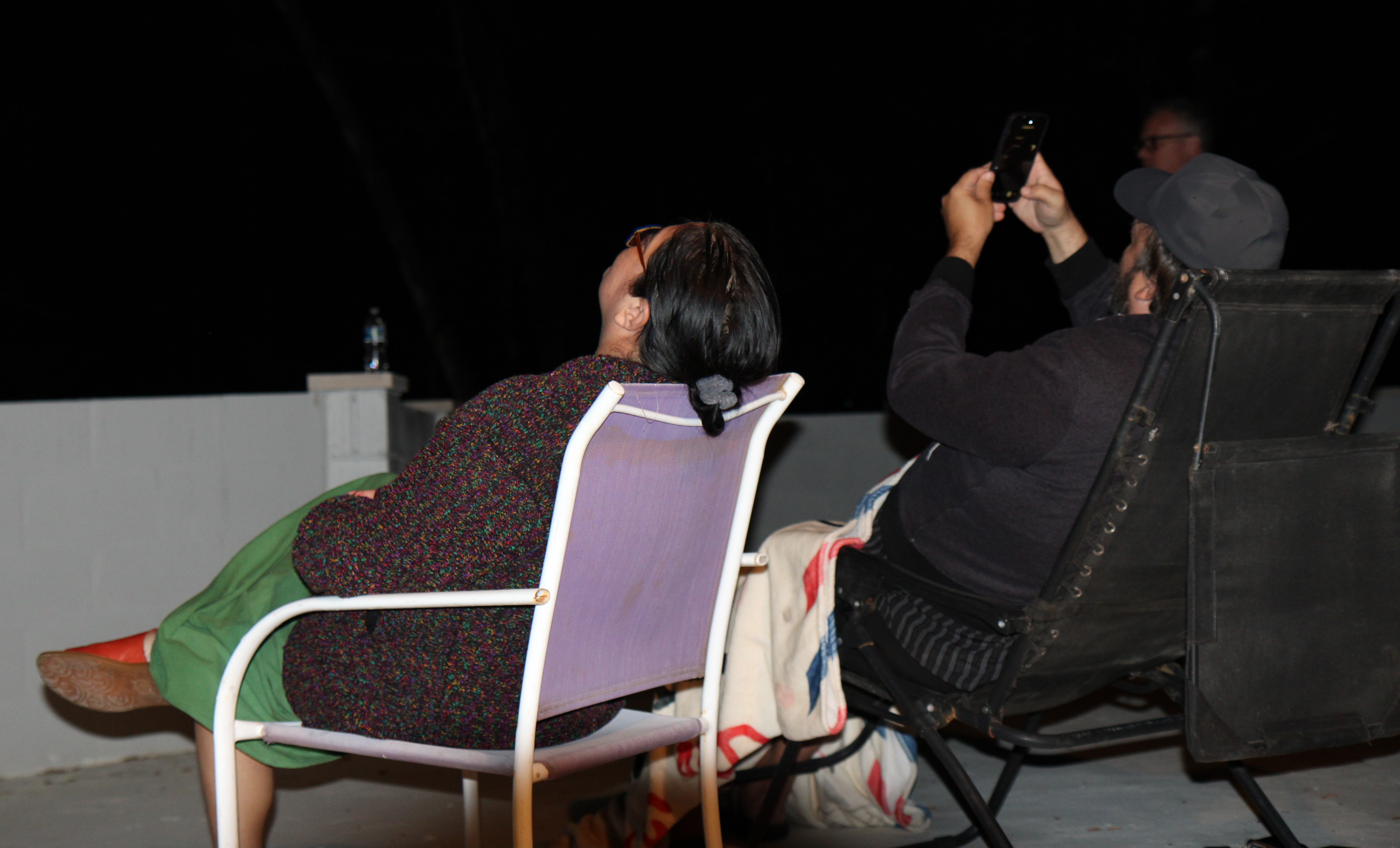 Guests gathered on the rooftop at night during a CE5 sky-watch event