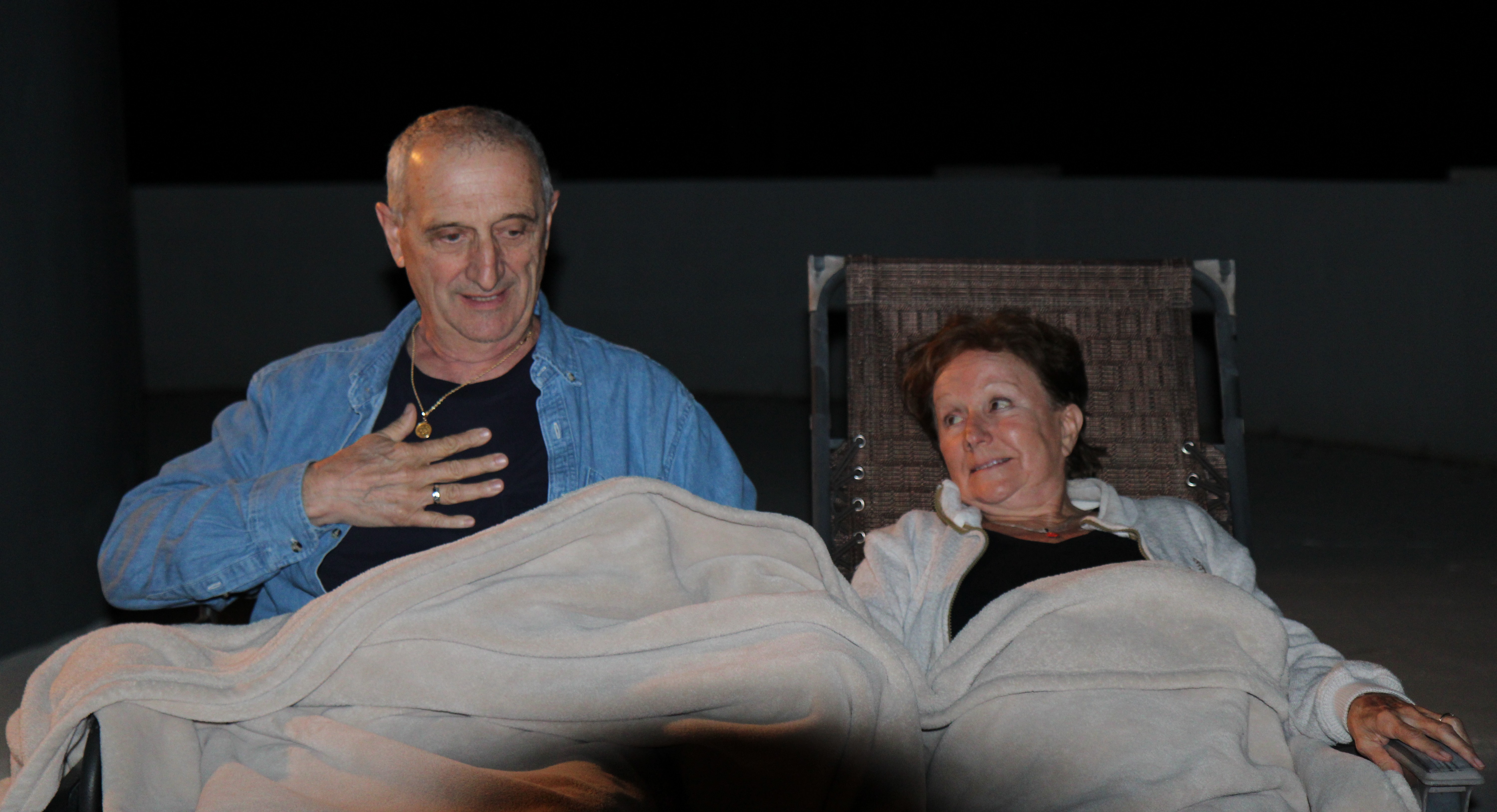 Two guests under blankets on the rooftop during a CE5 night